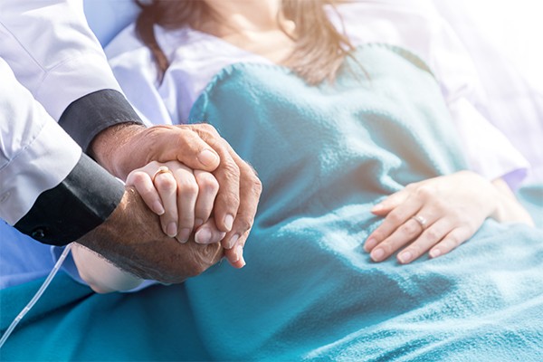 provider holding patient hand