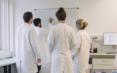 Researchers looking at whiteboard